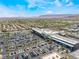Stunning aerial view of a suburban area with a shopping center and mountain backdrop at 2152 Jasper Bluff St # 103, Las Vegas, NV 89117
