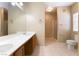 This bathroom has dual sinks, a large mirror, neutral walls, tile floor, and a glass shower at 2152 Jasper Bluff St # 103, Las Vegas, NV 89117