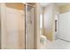 The bathroom features a glass shower, tile flooring, a toilet, and a small window at 2152 Jasper Bluff St # 103, Las Vegas, NV 89117