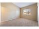 Bedroom featuring plush carpet, light walls, and a window providing natural light at 2152 Jasper Bluff St # 103, Las Vegas, NV 89117
