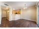 Open-concept dining area with dark wood flooring and a view of the kitchen at 2152 Jasper Bluff St # 103, Las Vegas, NV 89117