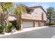 Two-story home with a three-car garage and well-maintained landscaping, providing curb appeal at 2152 Jasper Bluff St # 103, Las Vegas, NV 89117