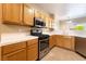 Functional kitchen with gas range, microwave and wood cabinets at 2152 Jasper Bluff St # 103, Las Vegas, NV 89117