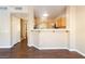 Bright, open living room with hardwood floors and kitchen access at 2152 Jasper Bluff St # 103, Las Vegas, NV 89117