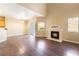 Spacious living area with fireplace, wood floors, and sliding door access at 2152 Jasper Bluff St # 103, Las Vegas, NV 89117
