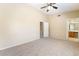 Large primary bedroom with carpet, ceiling fan, and a doorway to an en-suite bathroom at 2152 Jasper Bluff St # 103, Las Vegas, NV 89117