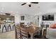 Open concept dining area featuring a wooden table, a bar and access to the living room at 2169 Rio Rancho Pointe Pl, Henderson, NV 89002