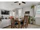 Comfortable dining area with a wooden table, stylish light fixture and natural light at 2169 Rio Rancho Pointe Pl, Henderson, NV 89002