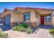 Charming single-story home with desert landscaping, brick accents, a gray garage door, and a red tile roof at 2169 Rio Rancho Pointe Pl, Henderson, NV 89002