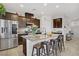 Modern kitchen with stainless steel appliances, granite countertops, and a breakfast bar at 2169 Rio Rancho Pointe Pl, Henderson, NV 89002