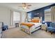 Cozy main bedroom with a large bed, dark blue accent wall and a ceiling fan at 2169 Rio Rancho Pointe Pl, Henderson, NV 89002