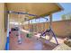 Covered patio area with swings, a trampoline and outdoor seating at 2169 Rio Rancho Pointe Pl, Henderson, NV 89002