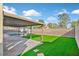 A private backyard with a pool, a covered patio area, and artificial grass for low maintenance at 2402 El Cid Ct, Henderson, NV 89014