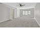 Bright bedroom features a ceiling fan, neutral paint, and carpet at 2402 El Cid Ct, Henderson, NV 89014