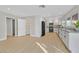 Light-filled living area connects kitchen and multiple rooms with neutral walls and streamlined floors at 2402 El Cid Ct, Henderson, NV 89014