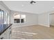 Bright living space with double doors to patio, big windows, and neutral wood flooring at 2402 El Cid Ct, Henderson, NV 89014