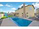 Enjoy the backyard swimming pool with slide and adjacent outdoor living space at 2402 El Cid Ct, Henderson, NV 89014