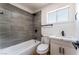 Bathroom with a tiled shower-tub, white vanity, and modern fixtures at 2481 San Marcos St, Las Vegas, NV 89115