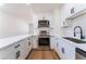 Updated kitchen boasting white cabinets, granite countertops, and stainless steel appliances at 2481 San Marcos St, Las Vegas, NV 89115