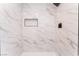 Close-up of a modern walk-in shower with white marble-look tile and niche at 2481 San Marcos St, Las Vegas, NV 89115