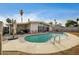 Backyard featuring a large pool, patio seating, mature trees, and desert landscaping at 2496 Golfers St, Las Vegas, NV 89142