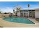 Large backyard with a spacious pool, patio seating, and mature landscaping at 2496 Golfers St, Las Vegas, NV 89142
