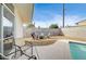 Cozy backyard with pool, chairs, a fire pit, and low maintenance desert landscaping at 2496 Golfers St, Las Vegas, NV 89142