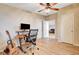 Bedroom with wood floors, ceiling fan, and a desk setup with a computer and guitar at 2496 Golfers St, Las Vegas, NV 89142