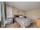 Bedroom with neutral carpet, stylish grey bed set and lamps at 2496 Golfers St, Las Vegas, NV 89142