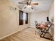 Bedroom with wood floors, ceiling fan, a window, and a desk setup with a computer at 2496 Golfers St, Las Vegas, NV 89142