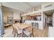 Open-concept dining area with a fireplace and connecting kitchen at 2496 Golfers St, Las Vegas, NV 89142