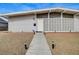 Inviting front entrance features a patterned privacy screen, gray gravel landscaping, and warm exterior lighting at 2496 Golfers St, Las Vegas, NV 89142