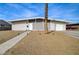 Charming single-story home featuring a unique patterned privacy screen, gravel landscaping, and a one-car garage at 2496 Golfers St, Las Vegas, NV 89142