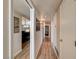 Hallway view of the living room area and access to bedrooms with new flooring at 2496 Golfers St, Las Vegas, NV 89142