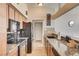 Modern kitchen featuring granite countertops, stainless appliances, and dark wood cabinetry at 2496 Golfers St, Las Vegas, NV 89142
