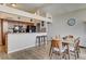 Open concept kitchen and dining area with breakfast bar seating and wood floors at 2496 Golfers St, Las Vegas, NV 89142