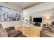 Warm and inviting living room with wood floors, comfortable couches, and modern entertainment center at 2496 Golfers St, Las Vegas, NV 89142