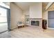Cozy living room features a brick fireplace and glass door to the outside pool at 2496 Golfers St, Las Vegas, NV 89142