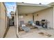 Inviting covered patio with outdoor seating and grill, perfect for relaxing and entertaining at 2496 Golfers St, Las Vegas, NV 89142