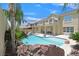 The backyard boasts a large swimming pool with a rock feature, ideal for outdoor entertaining at 2555 Antique Blossom Ave, Henderson, NV 89052