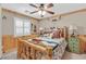 Rustic bedroom with wood trim, cowboy decor, and a unique log bed frame at 2555 Antique Blossom Ave, Henderson, NV 89052