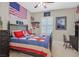 Charming bedroom featuring patriotic decor, a comfortable bed, and a bright, inviting atmosphere at 2555 Antique Blossom Ave, Henderson, NV 89052