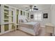 Bedroom with white furniture, unique striped wallpaper, and soft natural light through window shutters at 2555 Antique Blossom Ave, Henderson, NV 89052