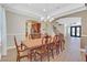 Elegant dining room with a chandelier and decorative archways into the entry and kitchen at 2555 Antique Blossom Ave, Henderson, NV 89052