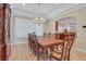 Formal dining room boasts elegant chandelier, and ample natural light with a view of the kitchen at 2555 Antique Blossom Ave, Henderson, NV 89052