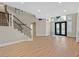 Bright foyer features a staircase with iron railings and double front doors, creating an inviting entrance at 2555 Antique Blossom Ave, Henderson, NV 89052