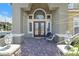 Inviting front porch with decorative lamps and pavers, offering a warm welcome to the home at 2555 Antique Blossom Ave, Henderson, NV 89052