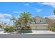 Stunning two-story home featuring manicured landscaping, mature palms, and a three-car garage at 2555 Antique Blossom Ave, Henderson, NV 89052
