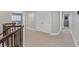 Upstairs hallway with neutral carpet, white trim, and multiple doorways to bedrooms and bathrooms at 2555 Antique Blossom Ave, Henderson, NV 89052