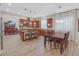 Charming kitchen features wood cabinets, stainless steel appliances, tile backsplash and island with seating at 2555 Antique Blossom Ave, Henderson, NV 89052